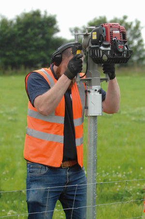 Man driving Clipex post into a fence line