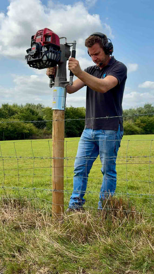 4 timber post installed along a fencline with an Easy Petrol Post Driver
