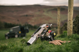 Post Driver lying on the ground next to some fence posts