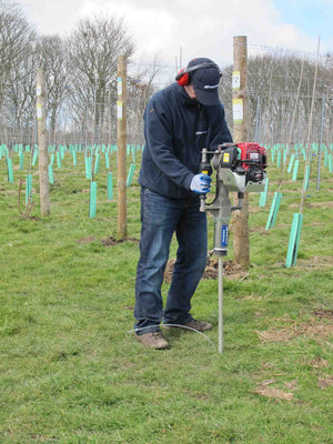 Post Driver being used in a vineyard to install a ground anchor