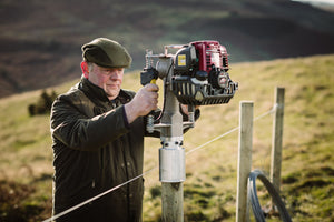 Farmer using the Multi UK A adapter on Easy Post Driver to install a fence post of 90mm round timber
