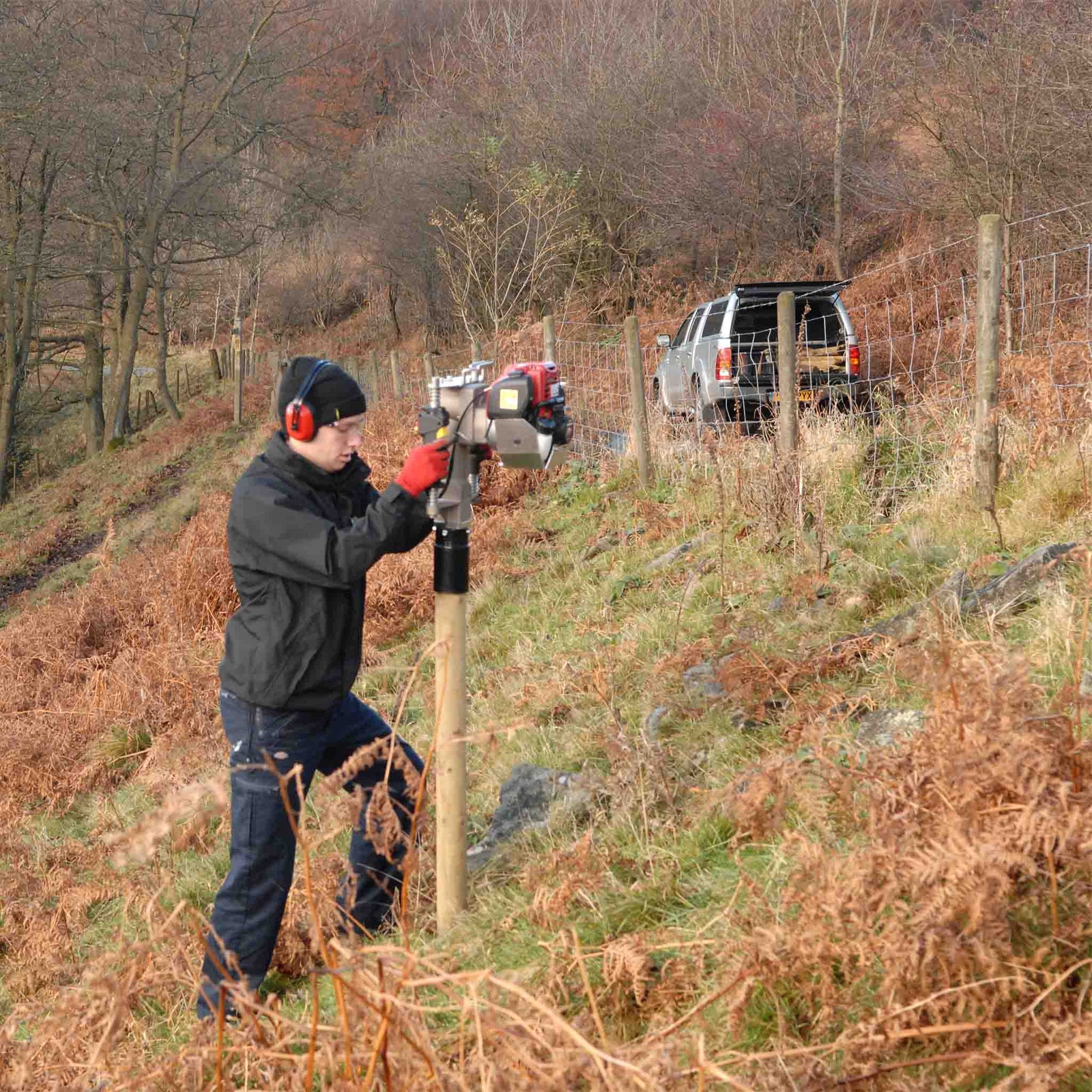 Fence posts installed on steep hillside
