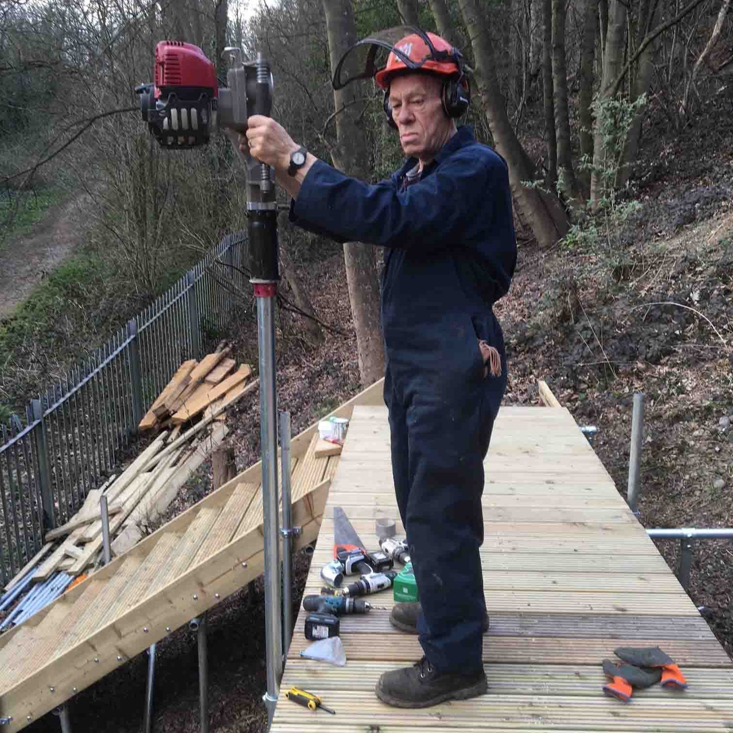 Contractor installing a boardwalk within a public woodland area