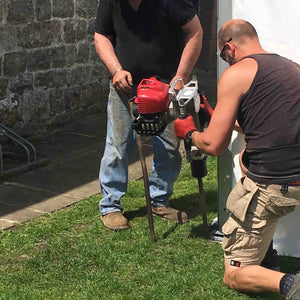 Marquee pins being installed through a fish plate in a modern marquee