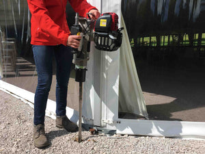 Marquee pins being installed to fasten down a marquee, using Easy Petrol Post Driver
