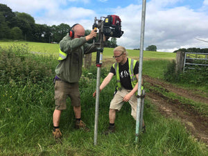 A festival site installing scaffold poles using easy petrol post driver